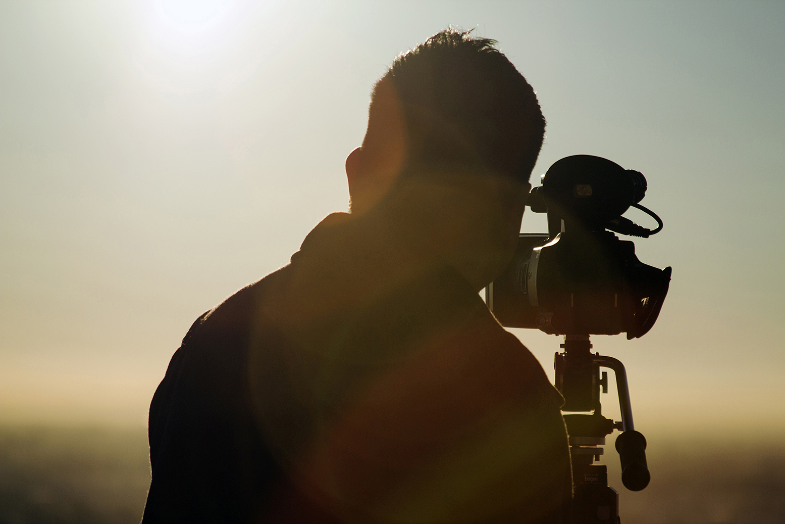 Aspiring Filmmaker shoots a time lapse outdoor in beautiful weather with sun rays around.