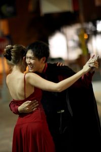 Ben Ren shares a laugh with his dance partner during an Argentine Tango event.